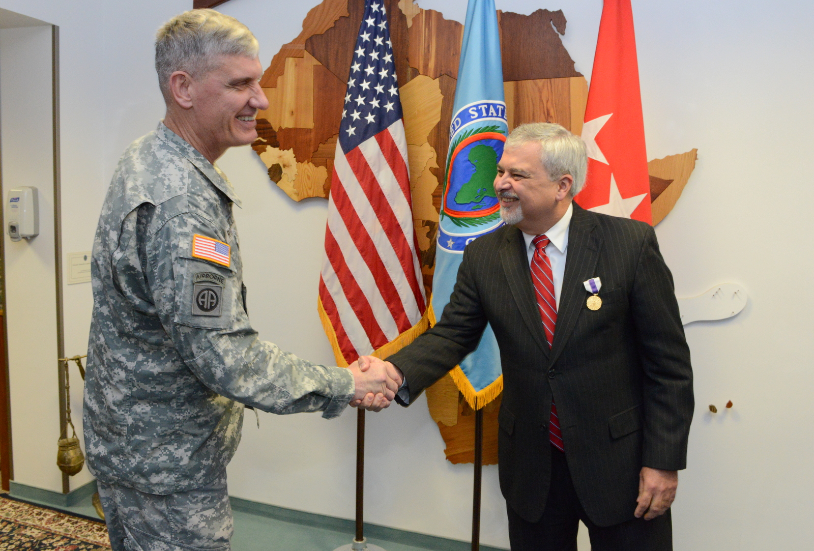 U.S. Army Gen. David Rodriguez, left, commander of U.S. Africa Command, shakes hands with Ambassador Phillip Carter III, the command’s outgoing deputy to the commander for civil military engagement, after awarding Carter the Joint Distinguished Civilian Service Medal at Kelley Barracks, U.S. Army Garrison Stuttgart, Germany, Sept. 17, 2015. Before becoming the command’s senior diplomat and civilian advisor to the commander in November 2013, Carter served as the U.S. Ambassador to Republic of Cote d’Ivoire.
