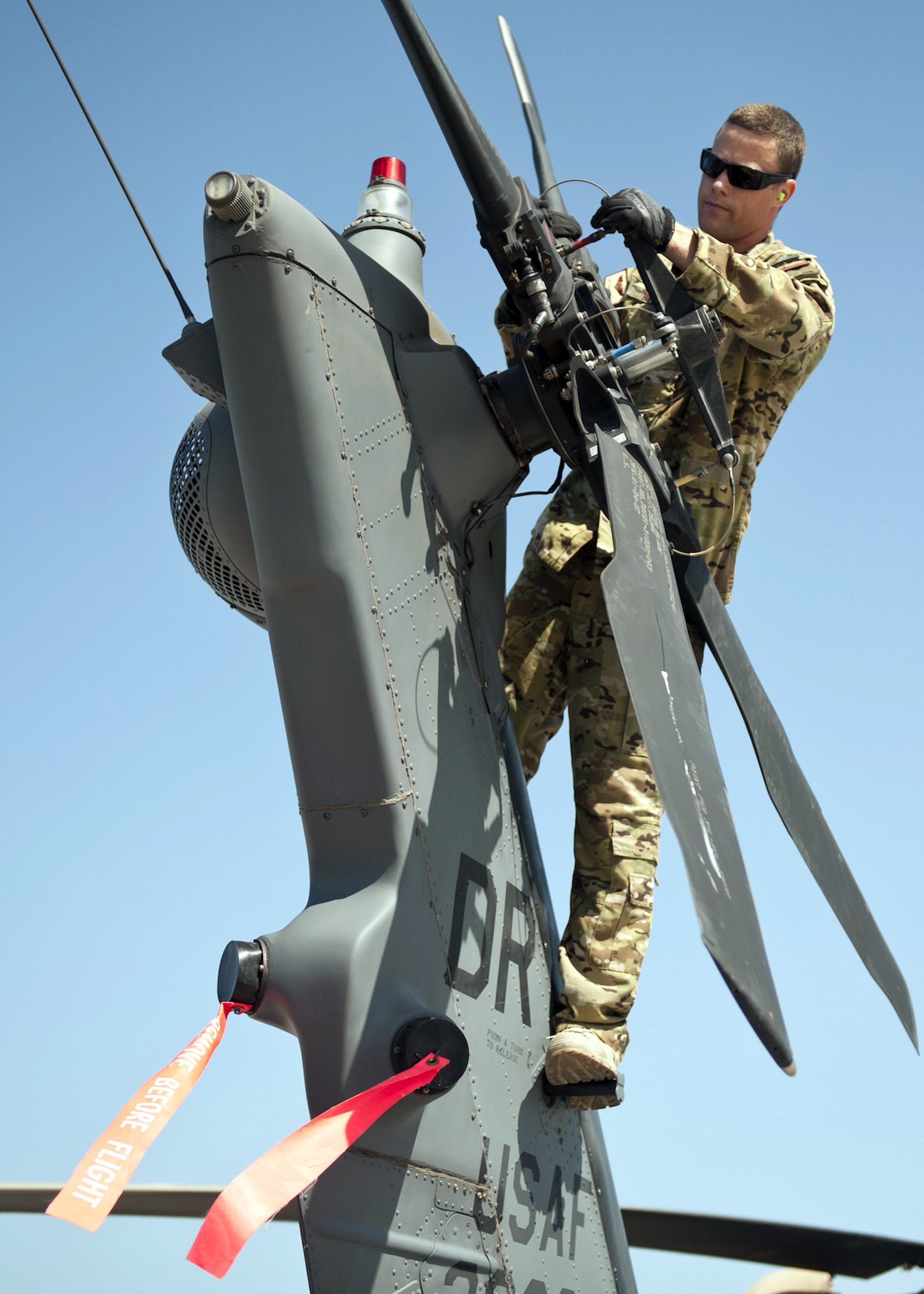 303rd Expeditionary Rescue Squadron Special Mission Aviator inspects Tail Motor on HH-60 Pave Hawk