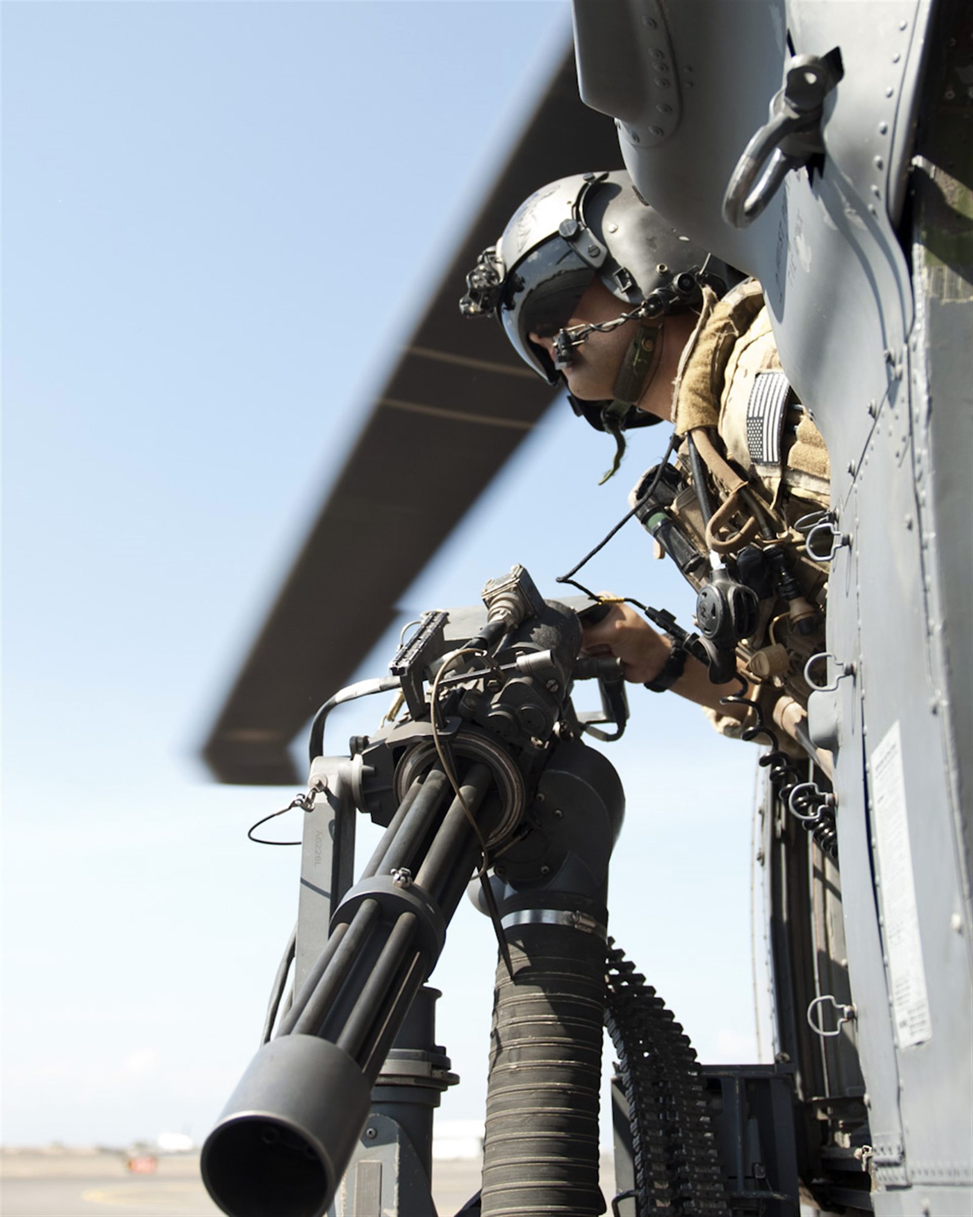 303rd Expeditionary Rescue Squadron Special Mission Aviator glances out of HH-60 Pave Hawk