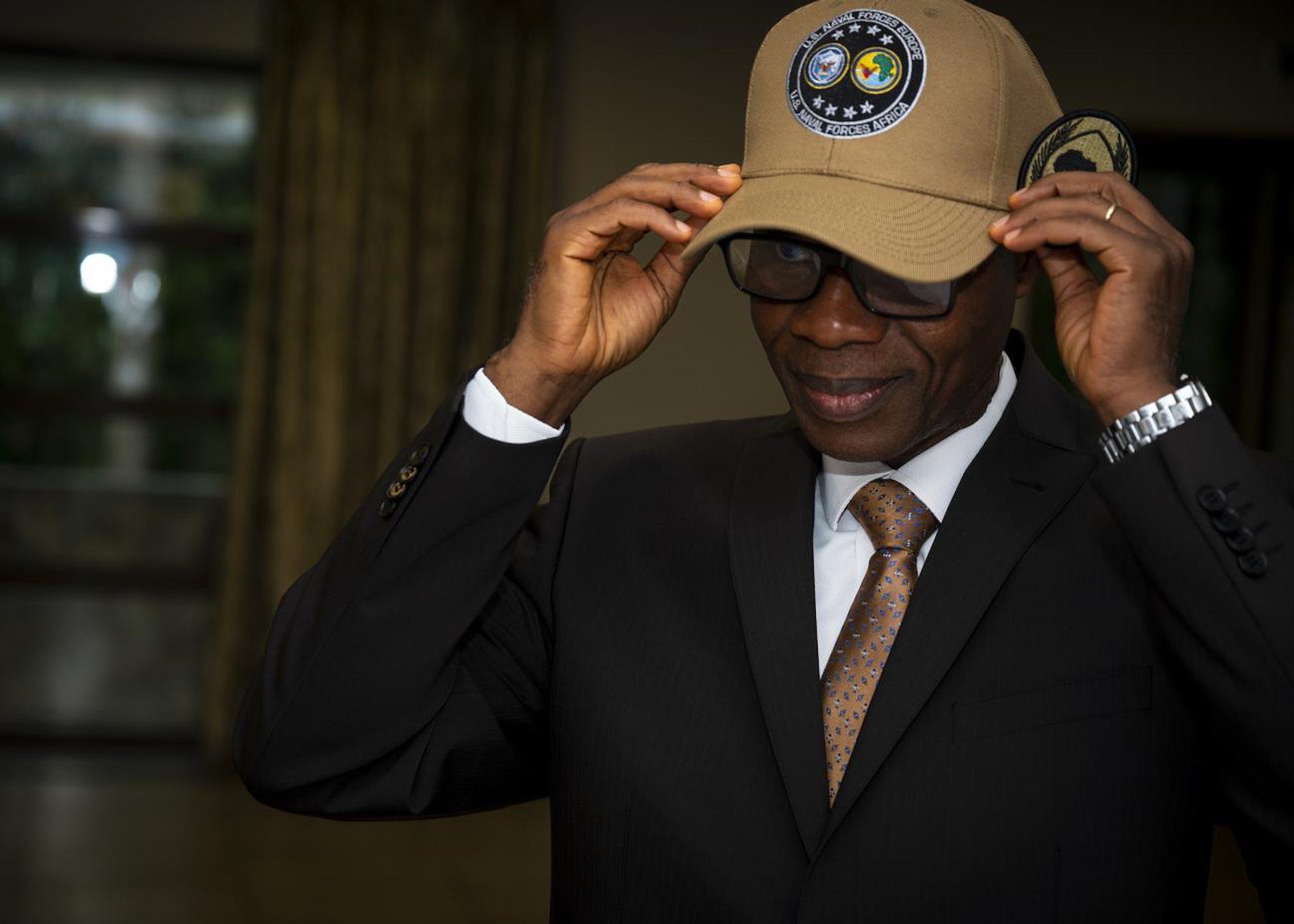 ACCRA, GHANA –– Prof. N’Dri Athanase Yao, Brig. Gen. (Ret.), dons a U.S. Naval Forces Africa, U.S. Naval Forces Africa command ball cap.